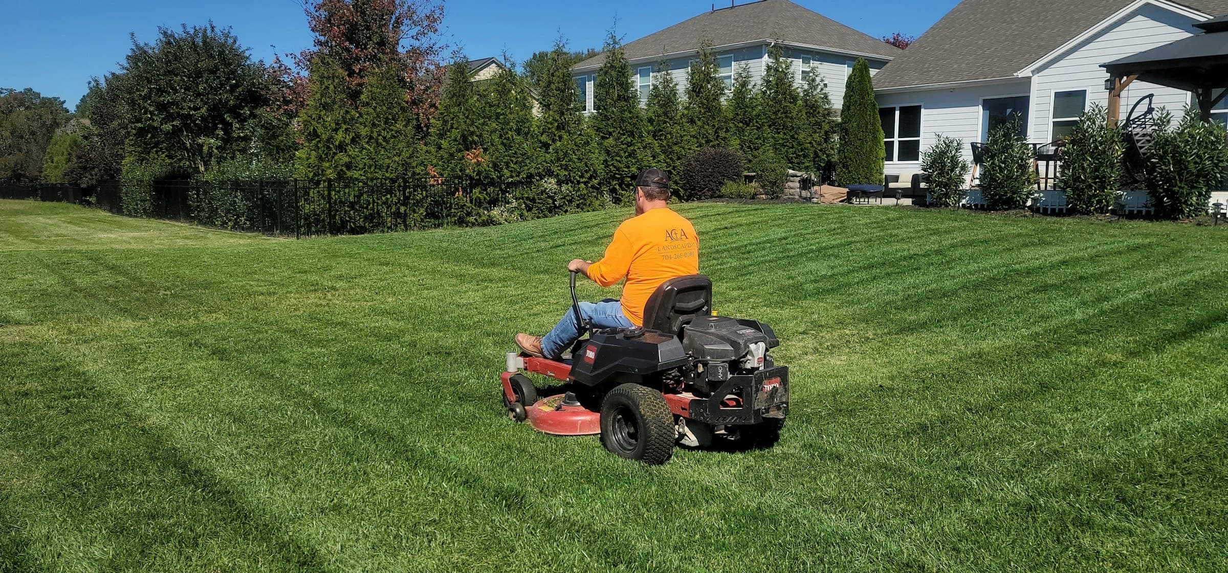 Zero-turn mower cutting a residential lawn
