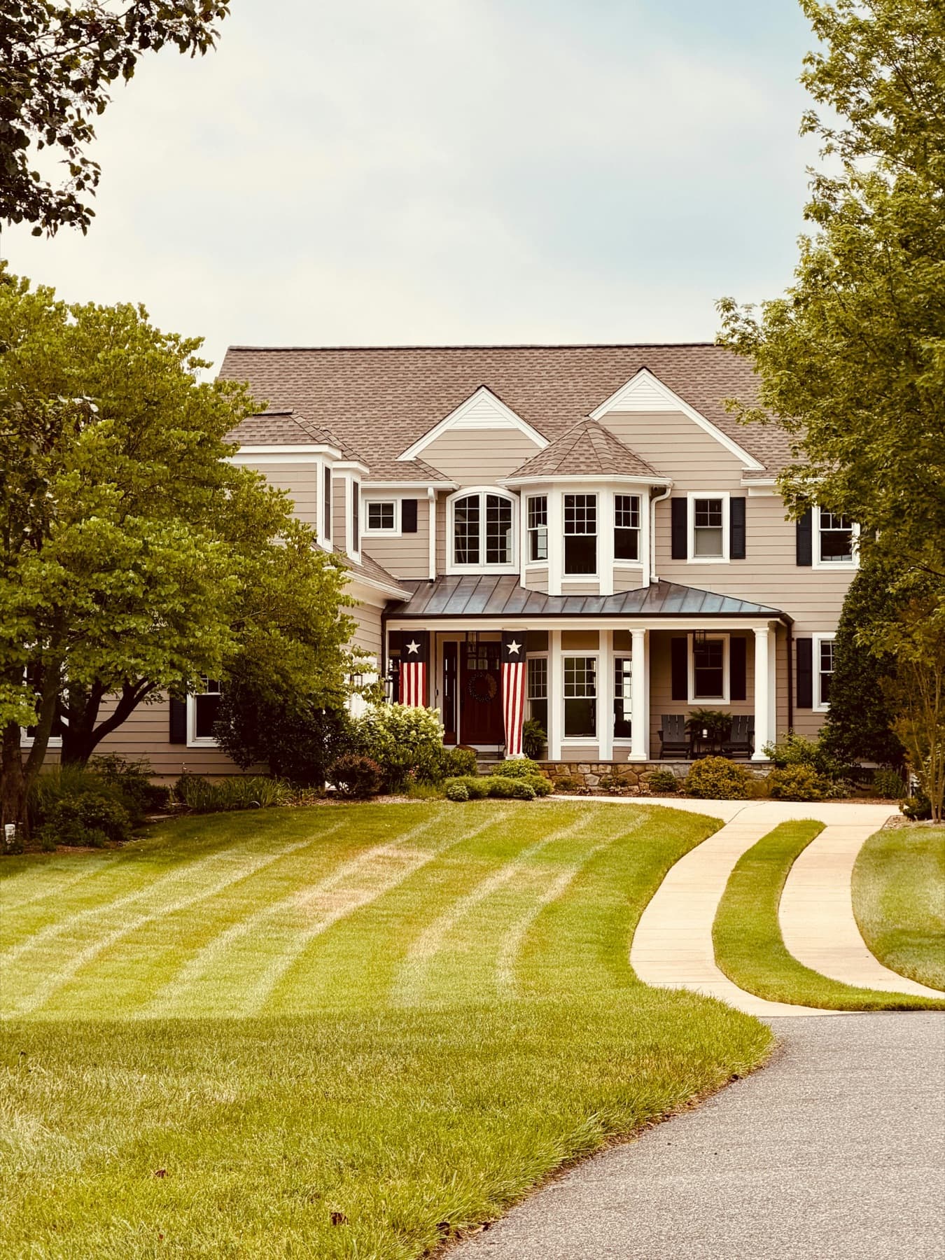 Manicured front lawn with a curved walkway
